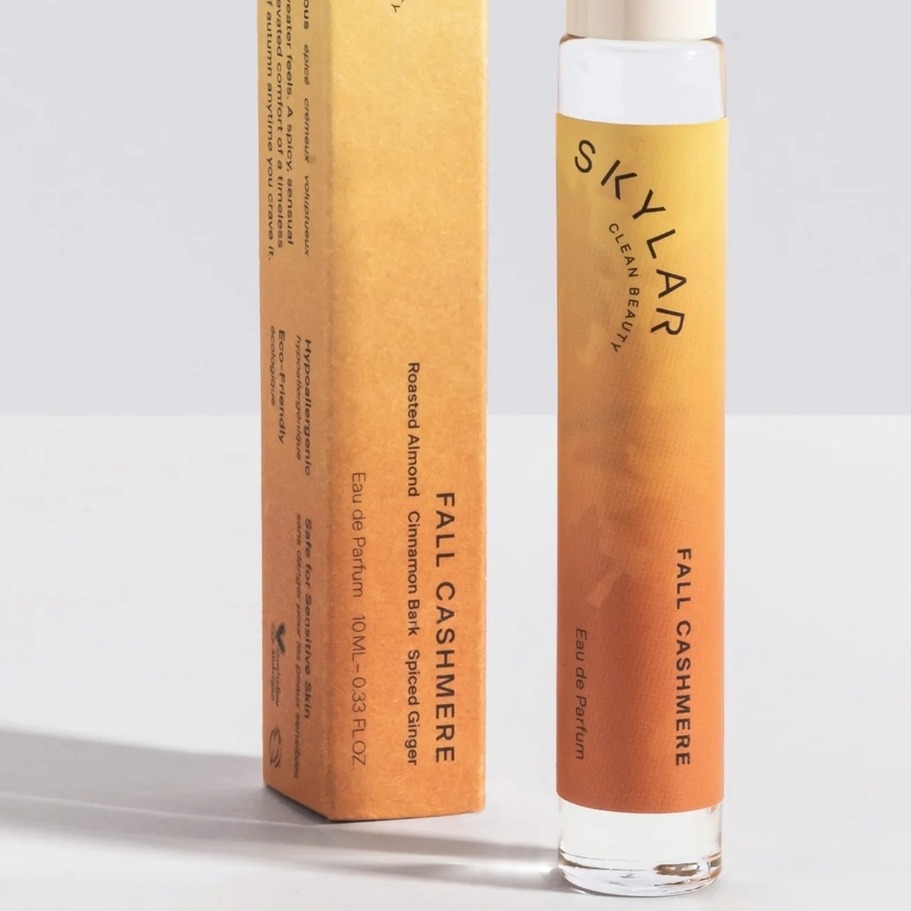 Photo of the Skylar Fall Cashmere rollerball perfume. Orange on a white background.